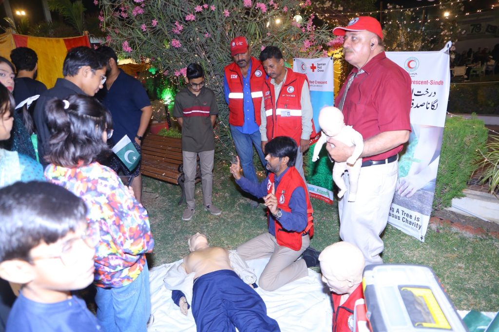 Pakistan Red Crescent medical team delivering emergency first aid at Independence Day celebrations in Karachi