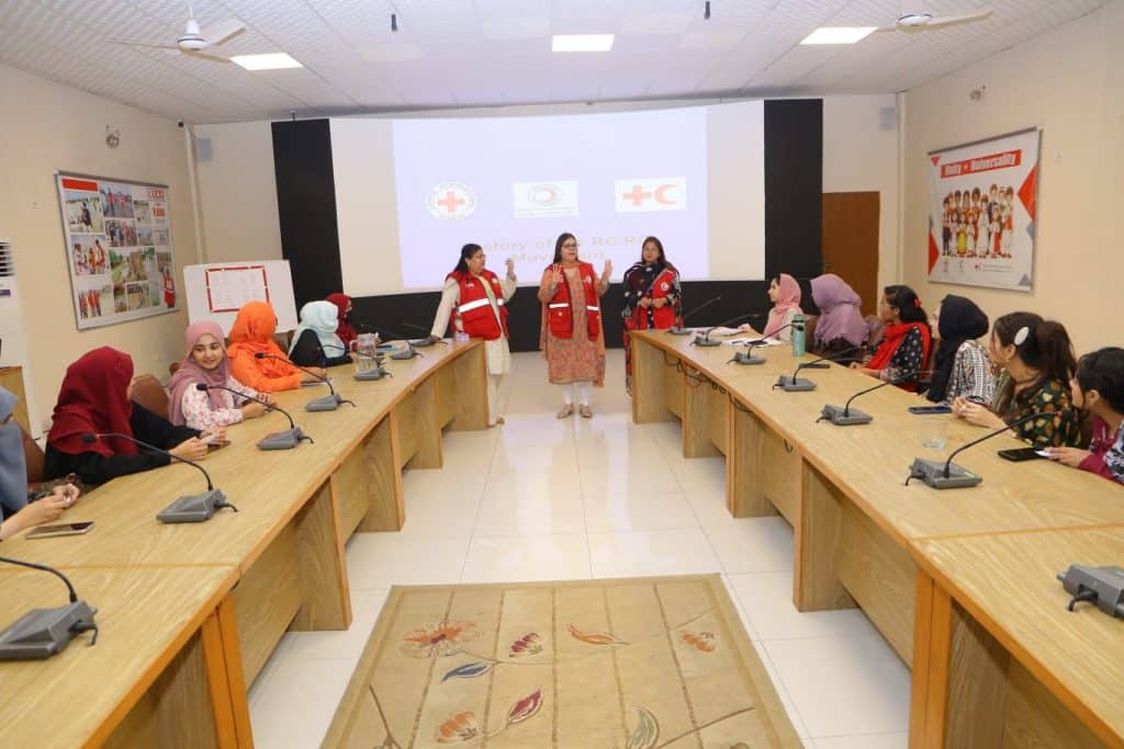 Volunteers engaging in team-building exercises to strengthen collaboration and teamwork during PRCS Sindh’s health orientation session.