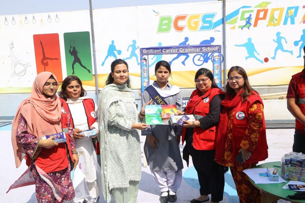 School principal Mrs Rimsha Tariq presenting prizes to students at awareness session