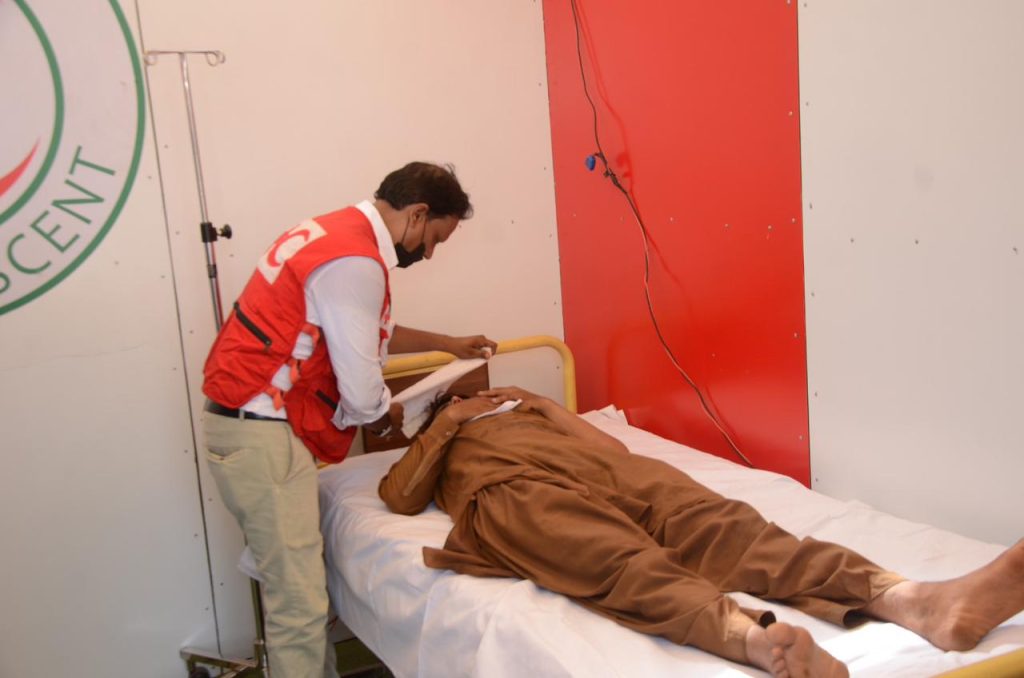 PRCS volunteers distributing clean drinking water during heatwave relief camp in Karachi