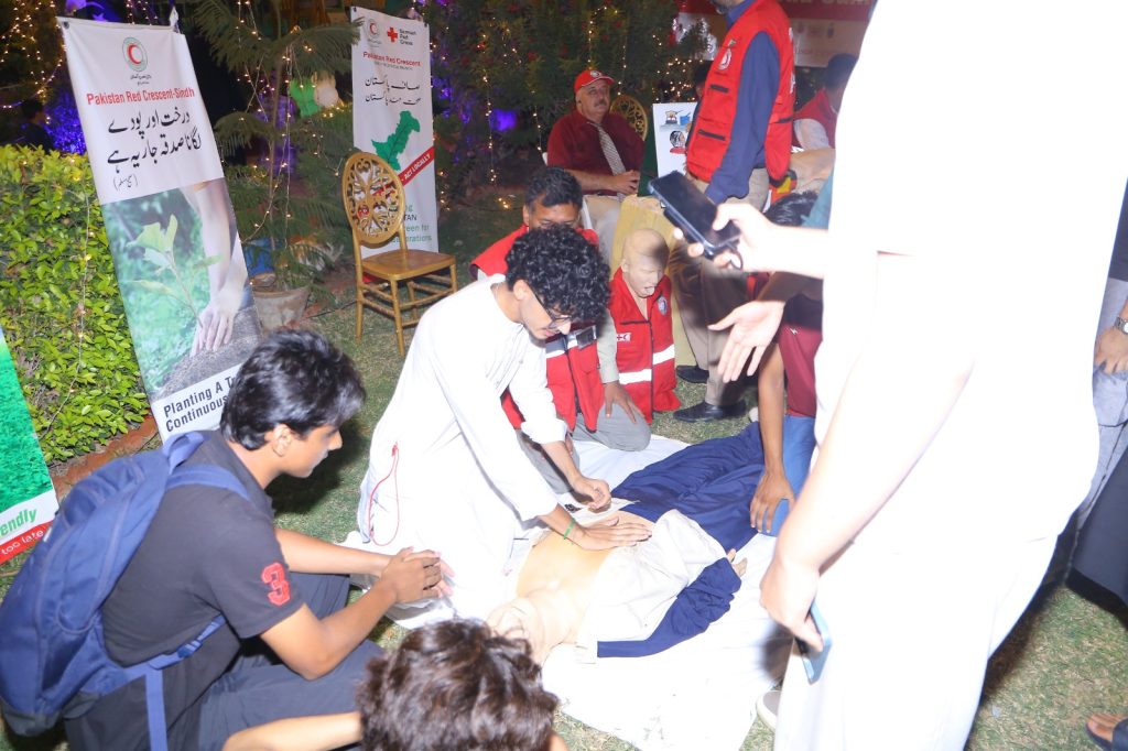 Pakistan Red Crescent medical team delivering emergency first aid at Independence Day celebrations in Karachi