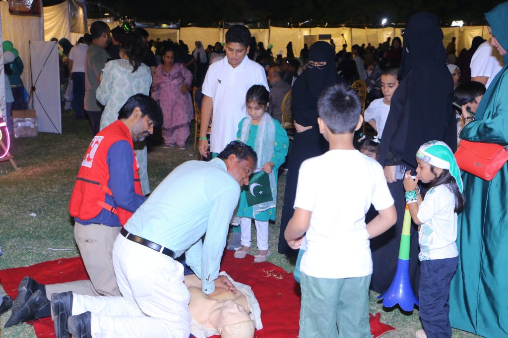 Pakistan Red Crescent medical team delivering emergency first aid at Independence Day celebrations in Karachi