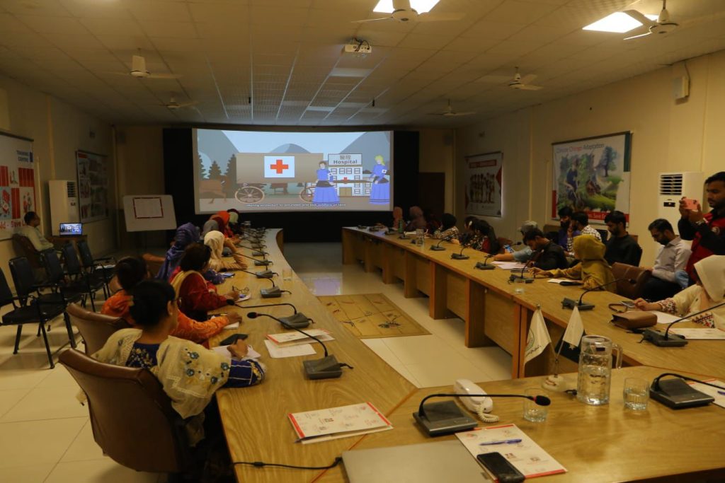 Volunteers engaging in team-building exercises to strengthen collaboration and teamwork during PRCS Sindh’s health orientation session.