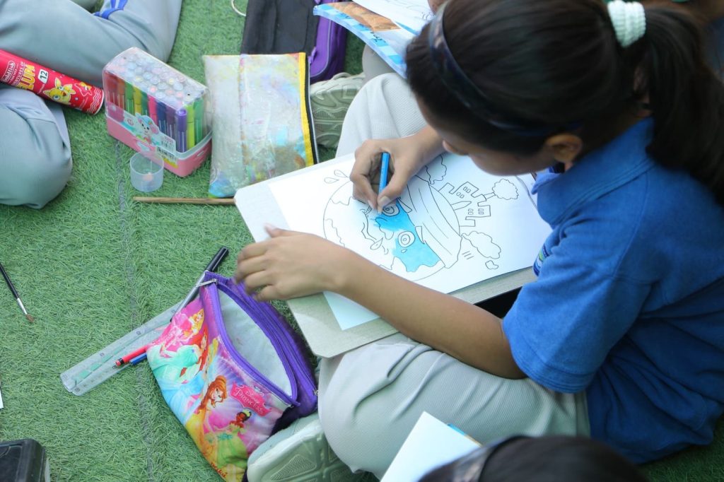 Children participating in drawing and coloring competition on climate change