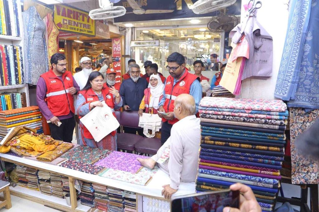 PRCS team distributing canvas bags during Plastic-Free Karachi campaign
