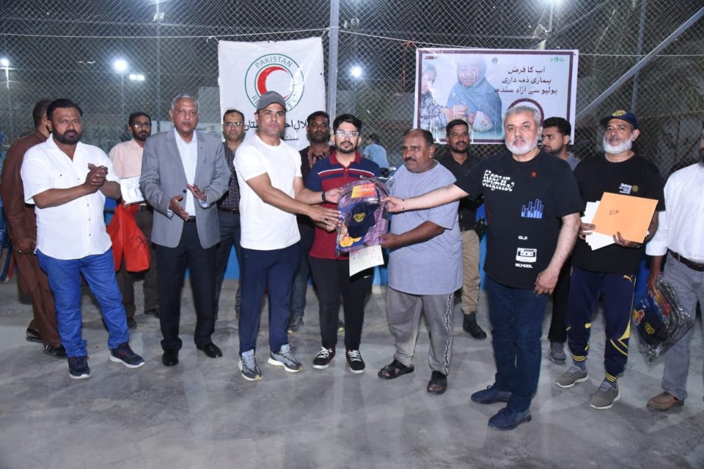 Polio workers receiving certificates after cricket match in North Nazimabad
